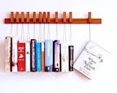 Custom made wooden book rack / bookshelf in Mahogany. Pins also work as bookmarks. Bookcase