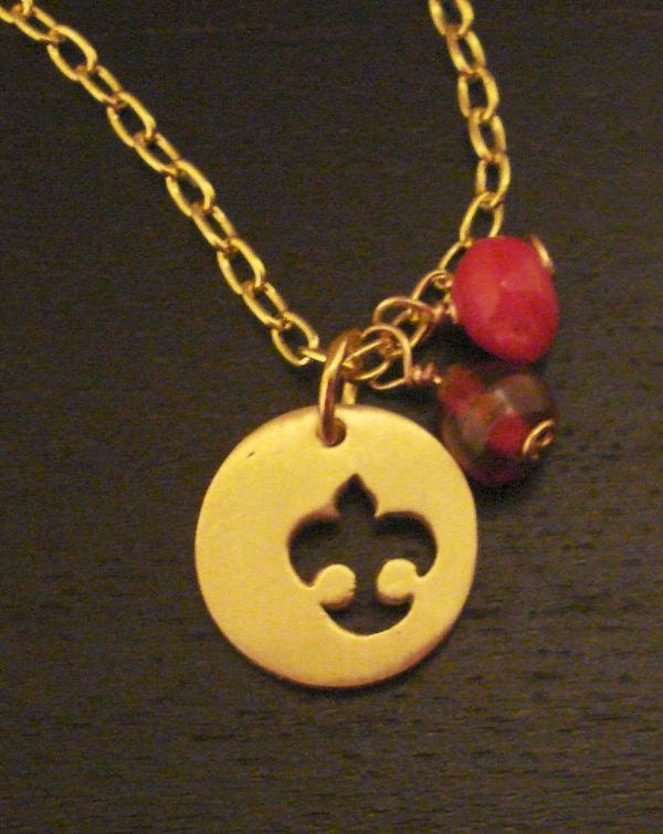 Be kind. Handmade brass bird motif logo necklace with red and brown beads