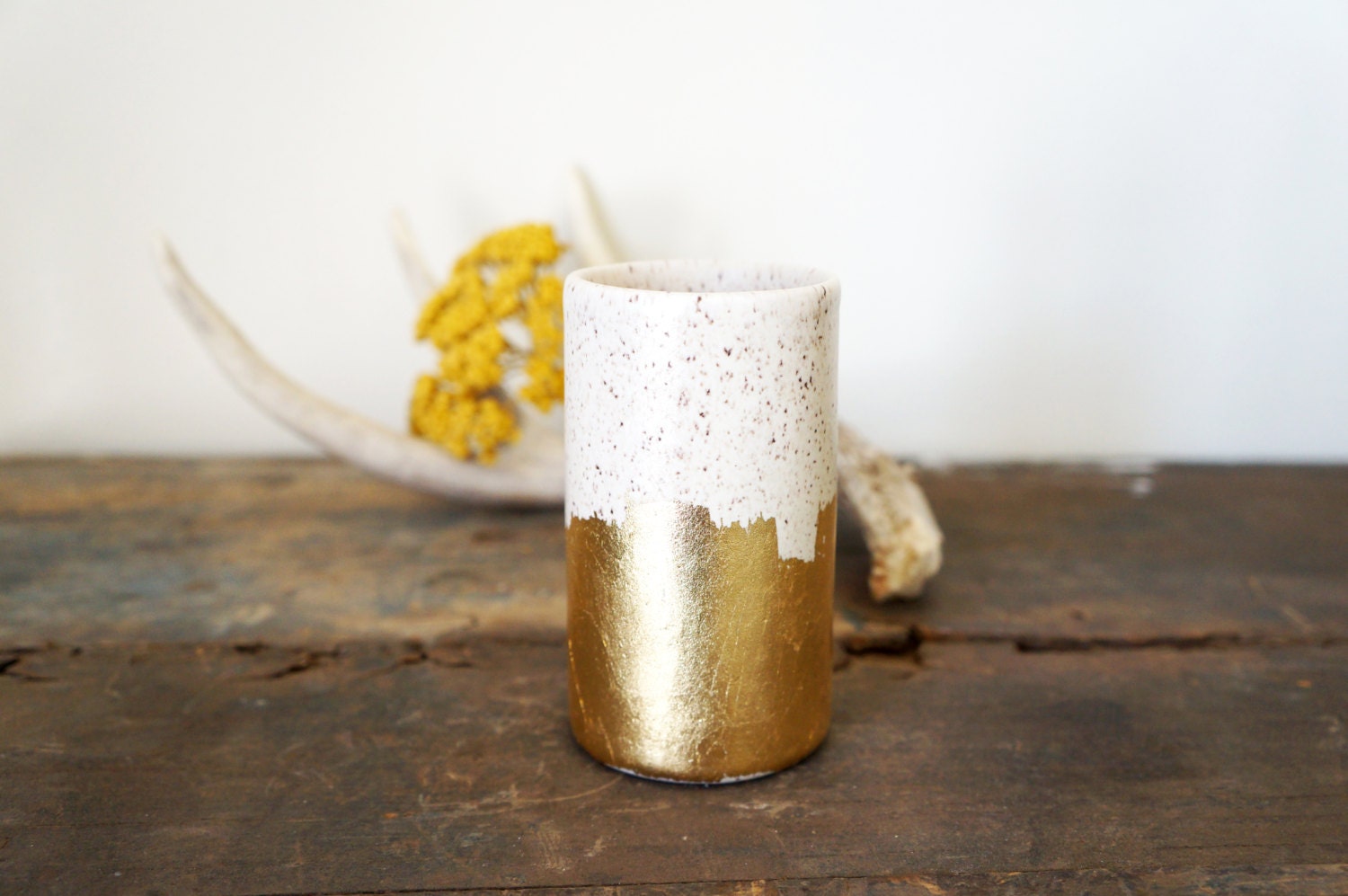 speckled vessel with gold brush strokes