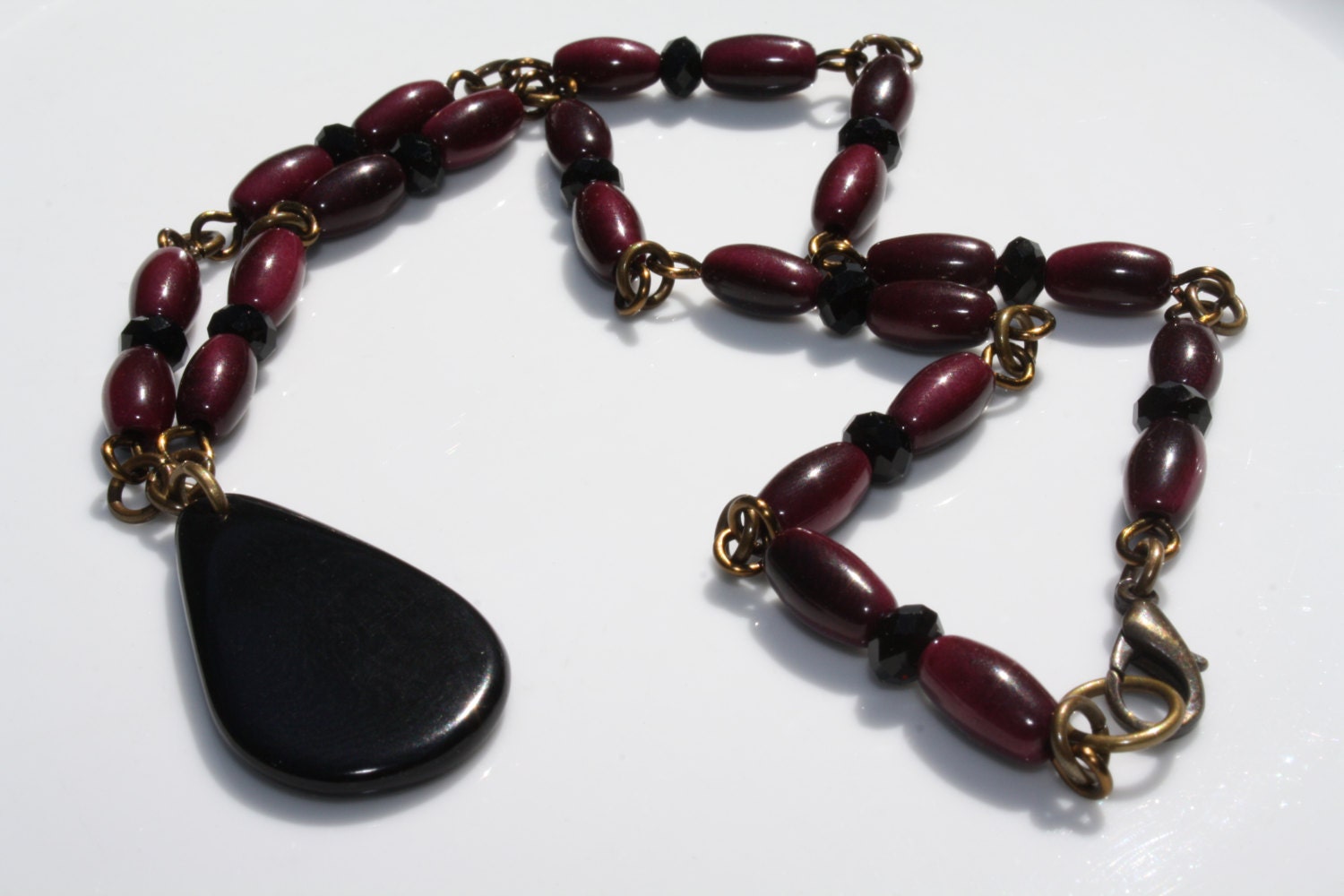 Antique Brass Burgundy Tagua Nut Necklace with Black Crystals and Black Teardrop Pendant