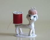 a Haberdashery Pincushion Porcelain figurine dog