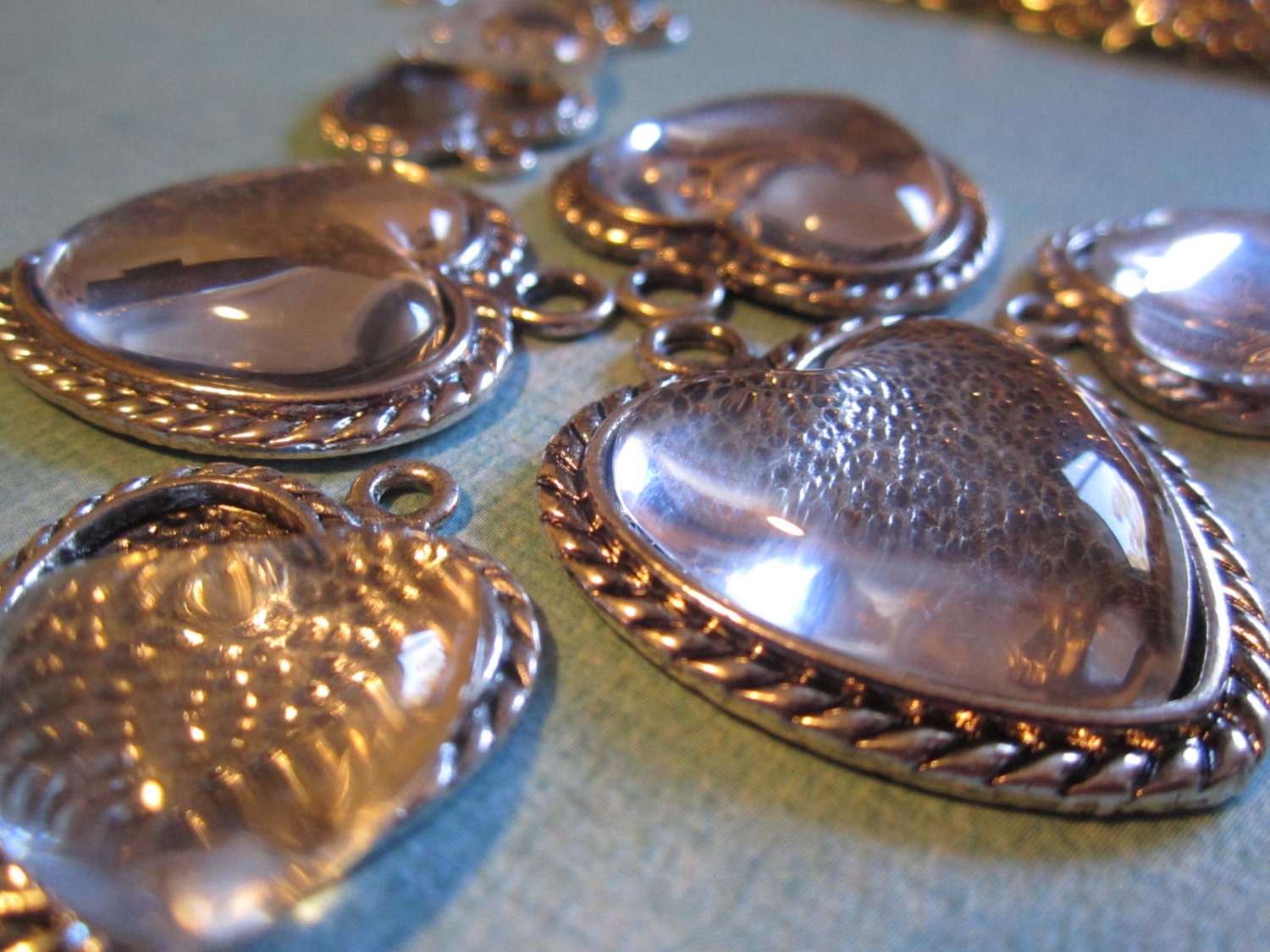 Make your own charm bracelet or necklaces with these heart shaped charm pendants