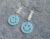 EAT SHIT smiley face earrings