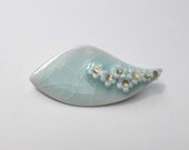 Ceramic Brooch, leaf shape, porcelain, in pale green celadon crackle glaze with white and gold flowers
