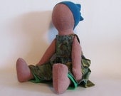 Eco-friendly light brown 11" doll with green and blue batik dress