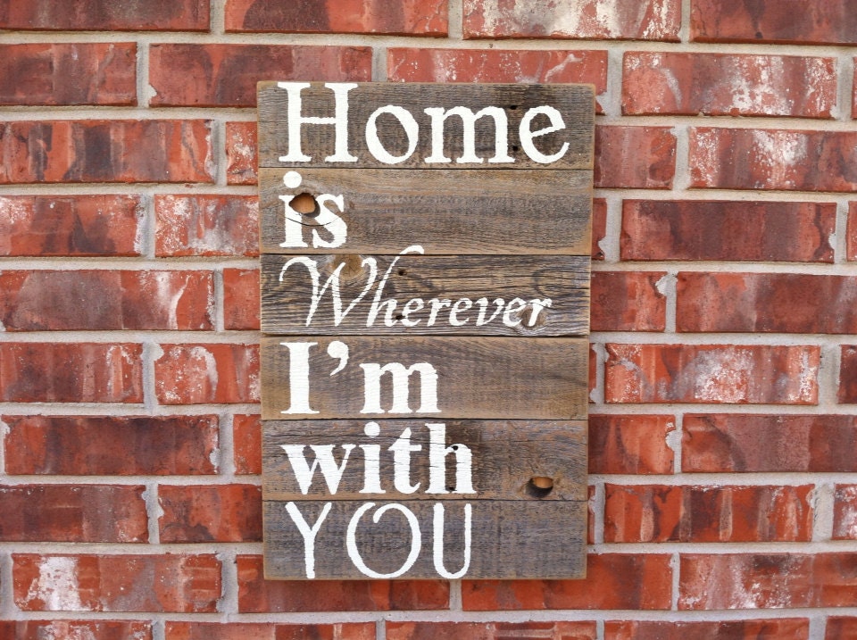 Home Is Wherever I'm With You in off white letters on a natural weathered cedar fence picket sign