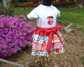 Flounced skirt with sash bow that ties in the front