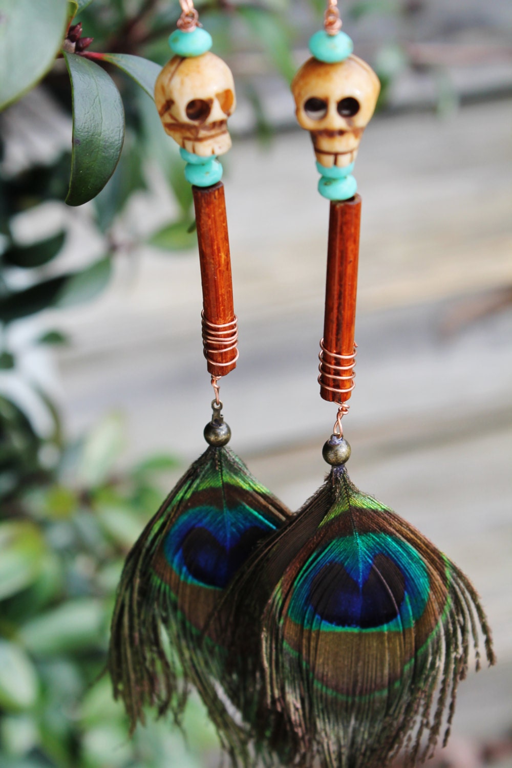 peacock feather skull earrings wrapped with copper wire, wood and turquoise beads uniquely handcrafted, 7 inches long