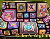 Crocheted afghan kaleidoscope colors, circles to squares, circles in squares, rainbow border