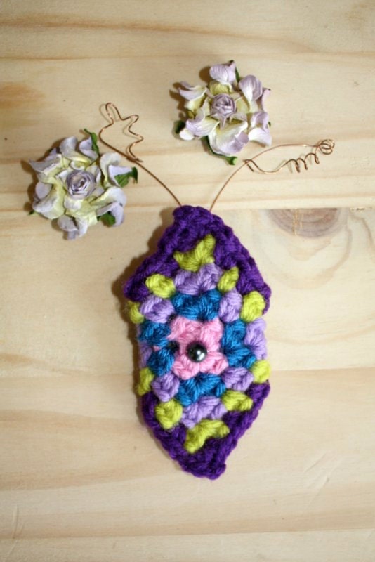 Ponytail cuff crocheted rich purple, spring green, lavender, royal blue, and pink colored with a silver colored pearl.