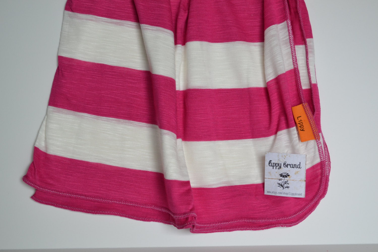 Baby girl striped blanket. --New style-- Soft stretchy fabric. Size 31 by 40 inches. Pink & cream wide stripes.  Made by lippy brand.