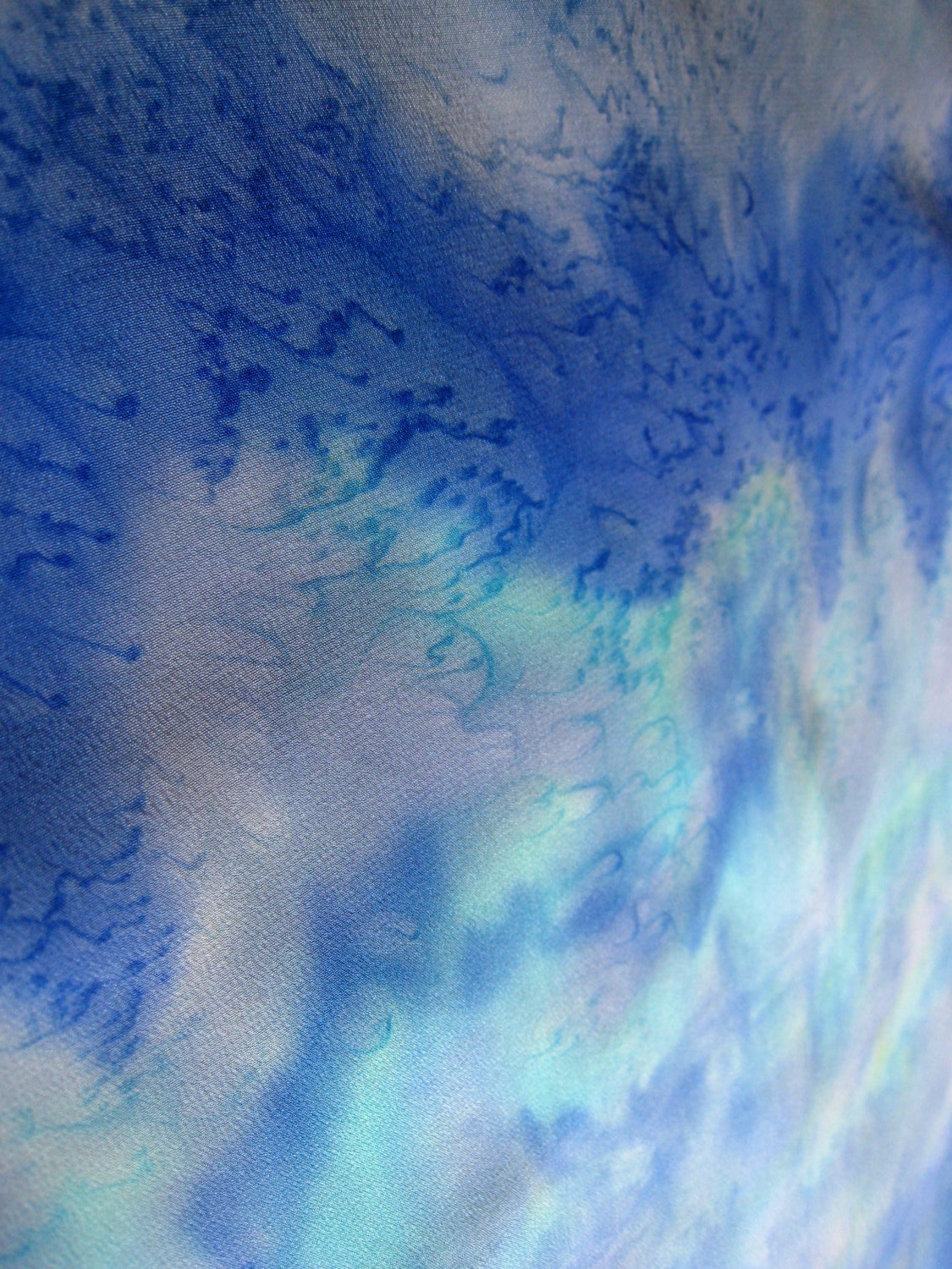Waterscape design creates a pool of blue shades on silk