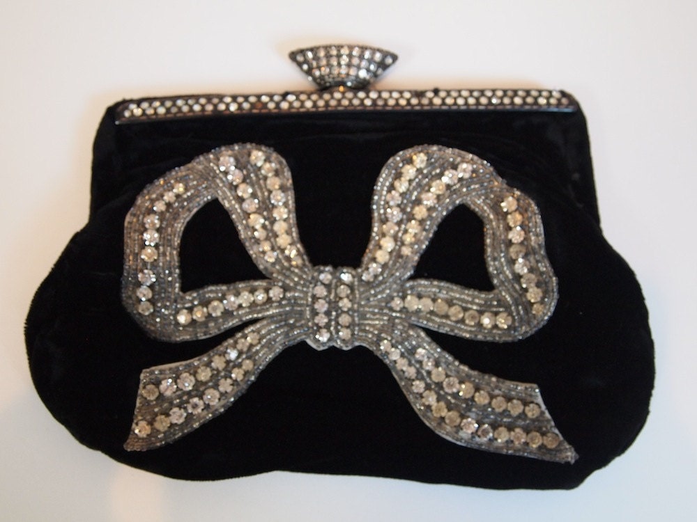 1930s black velvet clutch handbag with rhinestone and beaded bow appliqué detail and heavy silver and rhinestone close feature