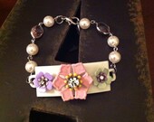 Metal tag bracelet with vintage metal flowers