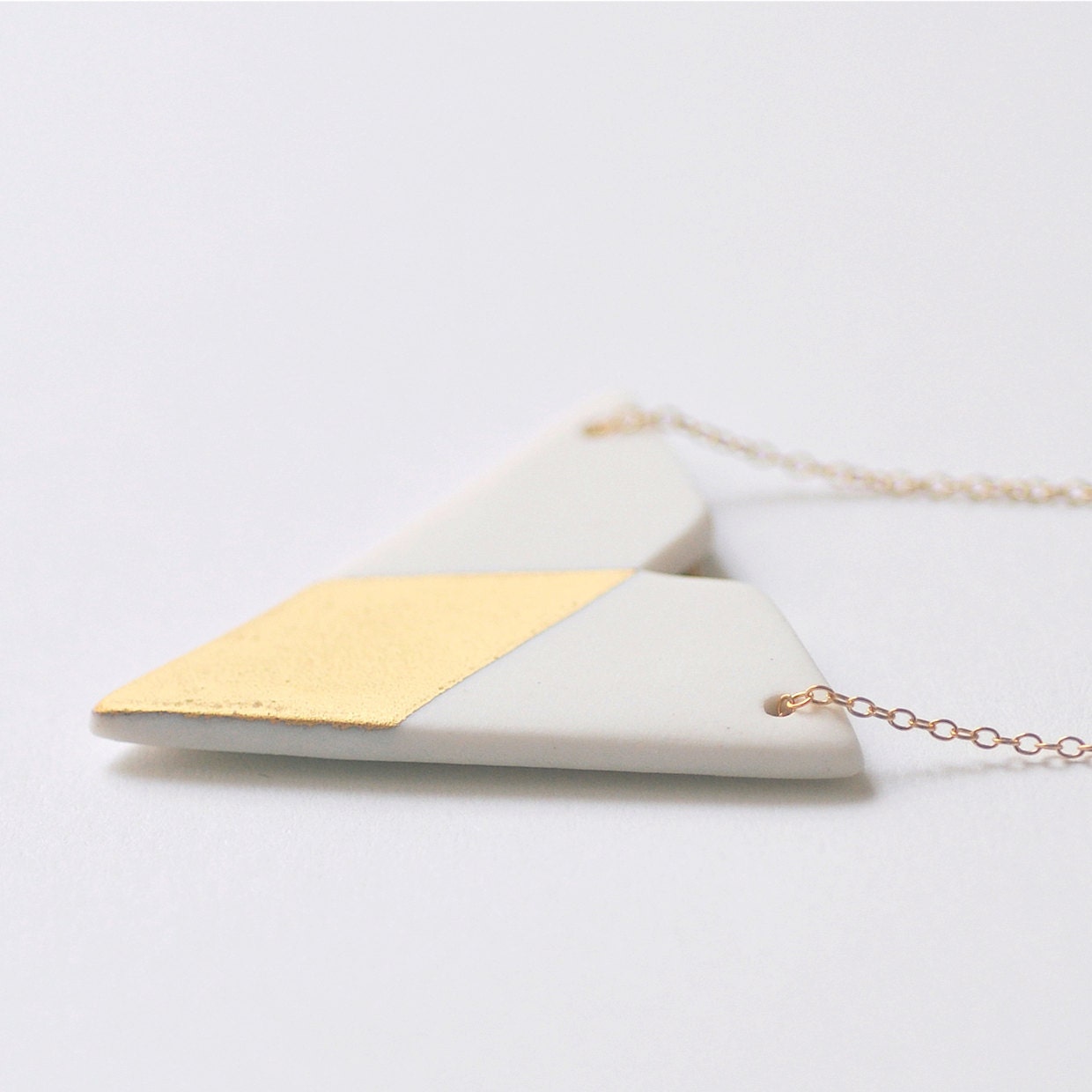 N a ï a - Simple geometric jewelry - Unglazed white porcelain necklace & matt fine gold - Triangle and diamond shaped - Eleïa Collection