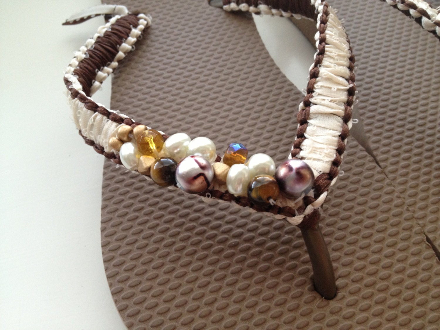 Brown and beige macrame ribbon flip flop with embellishments