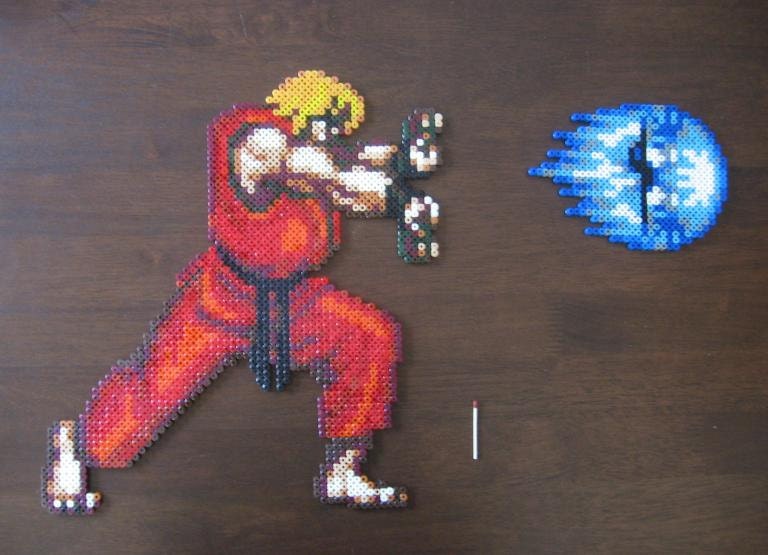 Ken from the SNES-game Street Fighter 2 in HADOUKEN-pose, 16-bit bead sprite