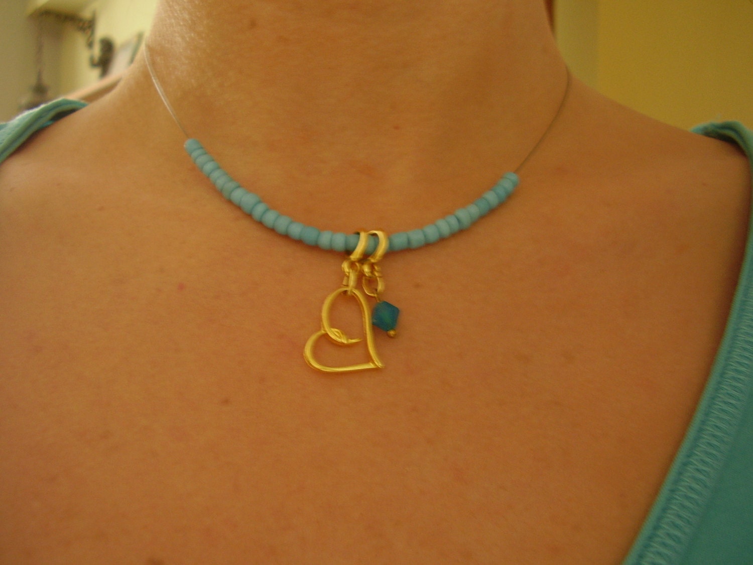 Turquoise beaded chocker  necklace with golden heart charm and  a tiny    czech glass pendant