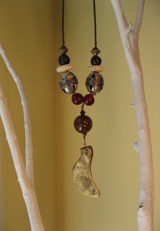 Beaded necklace with brass maple seed pod on waxed cotton cording