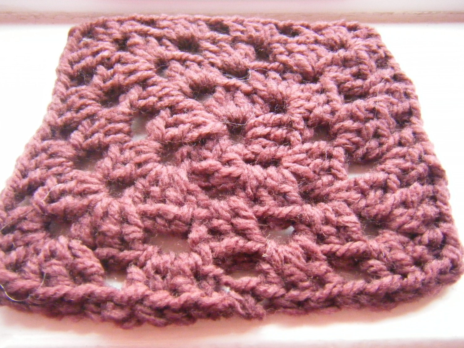 crocheted purple woolly coaster