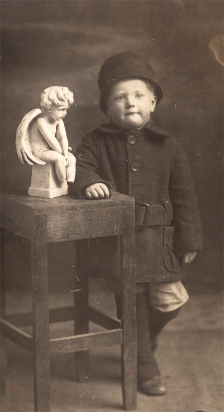 vintage photo 1910 Boy stands by grave Cupid Statue