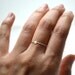 Tiny 14k solid gold disc on silver band, stacking ring,