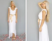 Marguerite: White bohemian sheath gown with flutter sleeves and deep neckline...
