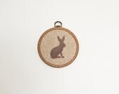 Hand-stitched hare silhouette in vintage embroidery hoop