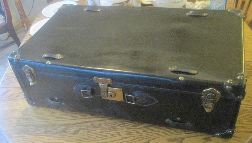 Black leather lg suitcase could be made into a neat coffee table.Vintage