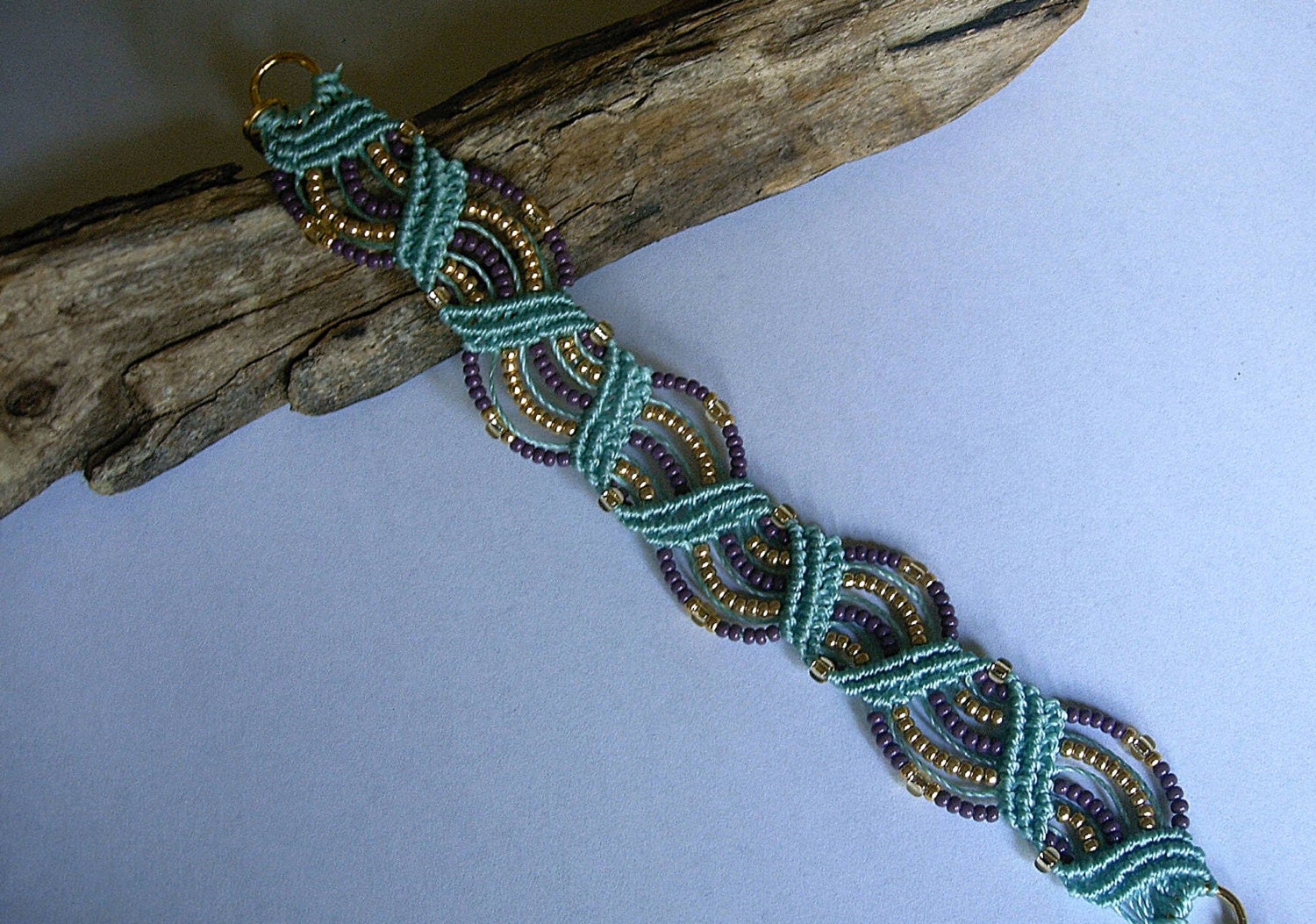Micro macrame bracelet in turquoise, purple and gold. Macrame jewelry.