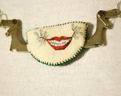 Winged smile: Unusual necklace of embroidery and typewriter parts