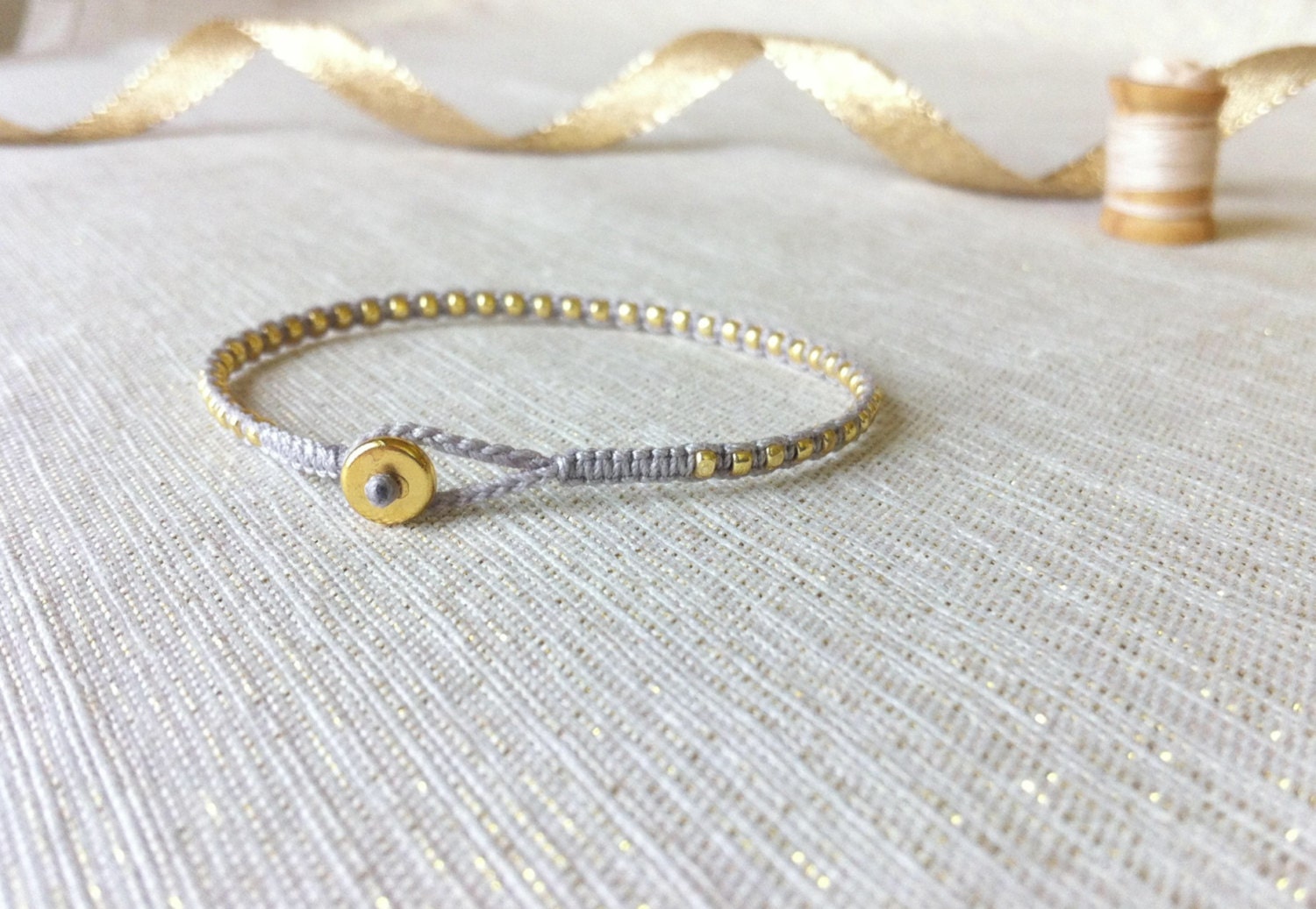 micro macrame wrap bracelet with faceted gold bead nuggets in bead closure. max.