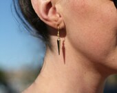 Gold spike earrings.