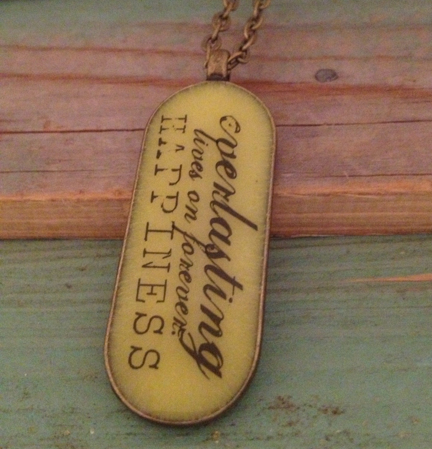 Yellow resin  pendant with lovely words. Large oval 45mm x 18. Bronze finish.