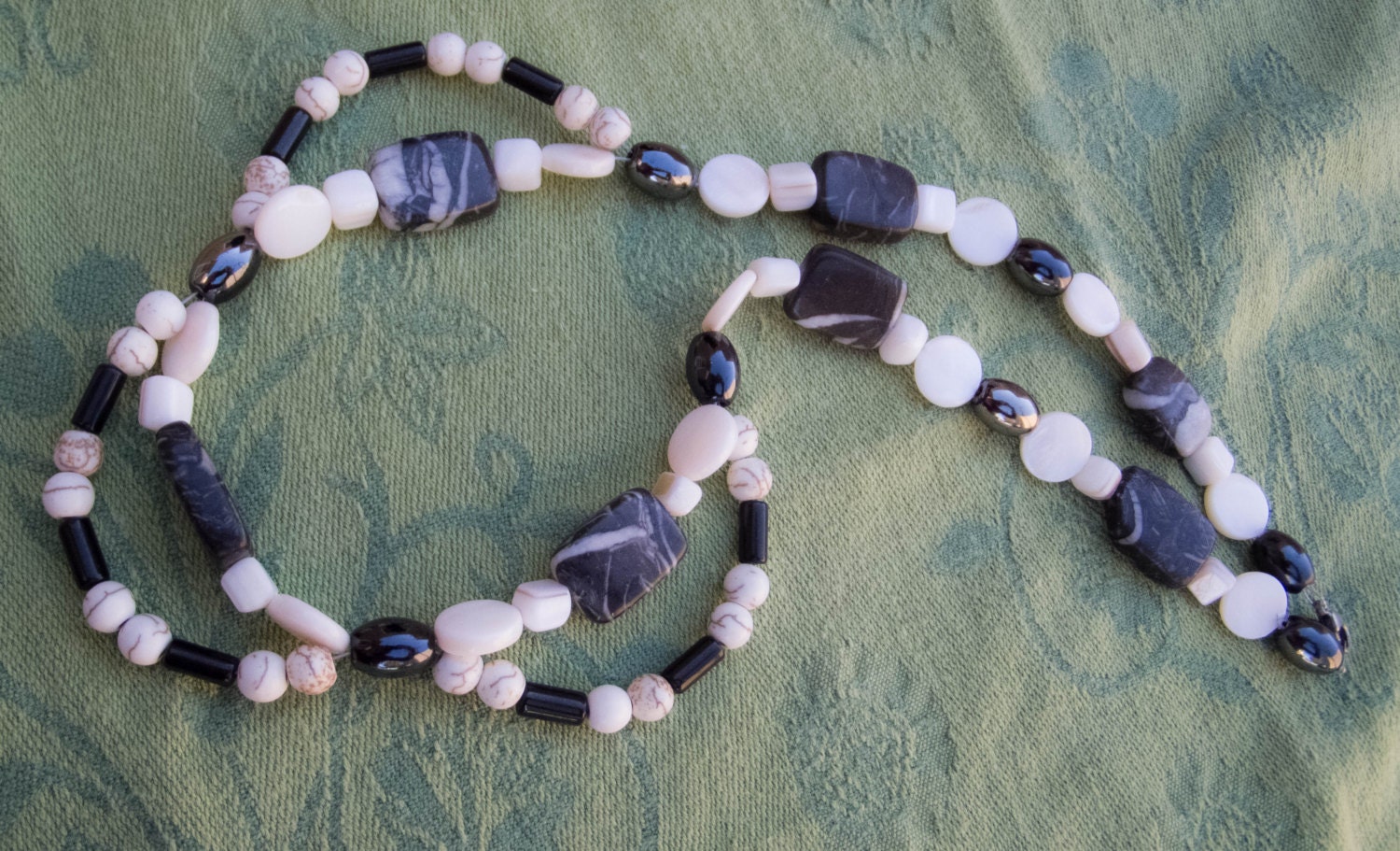 Black, Gunmetal and Cream: A double-strand necklace in glass, shell and stone