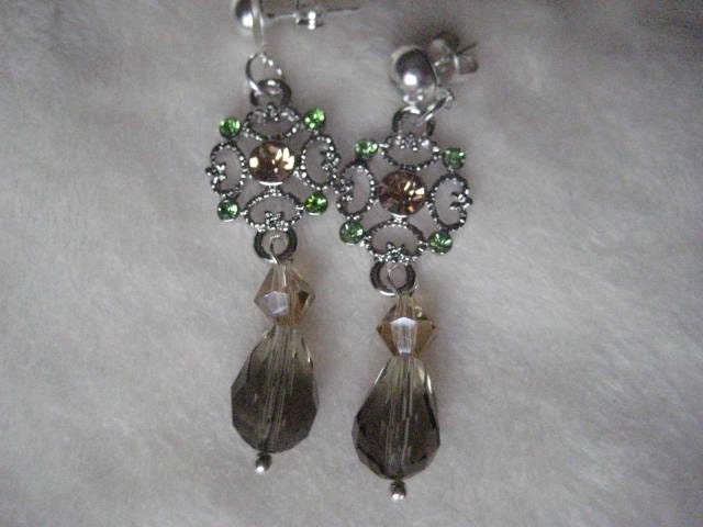 OMG-Stunning. Citrine and Green crystals embedded in pewter finding finished with smokey quartz drop. Silvertone earring post.