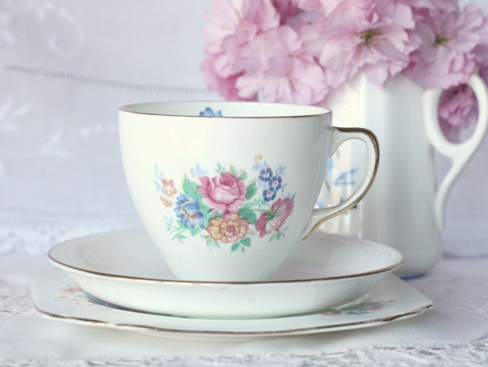 Sweet tea cup, saucer and plate: English bone china tea set with lovely rose pattern and tiny blue flower in cup