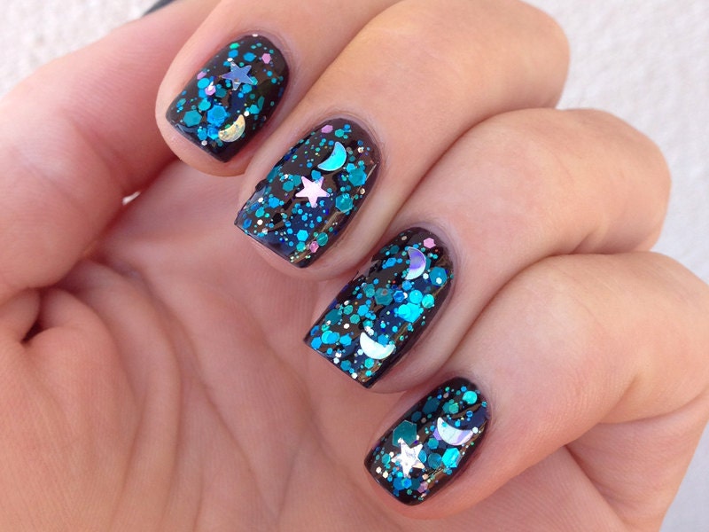 Nail polish - "Falling Skies" stars and moons with blue, teal and violet glitter in a clear base