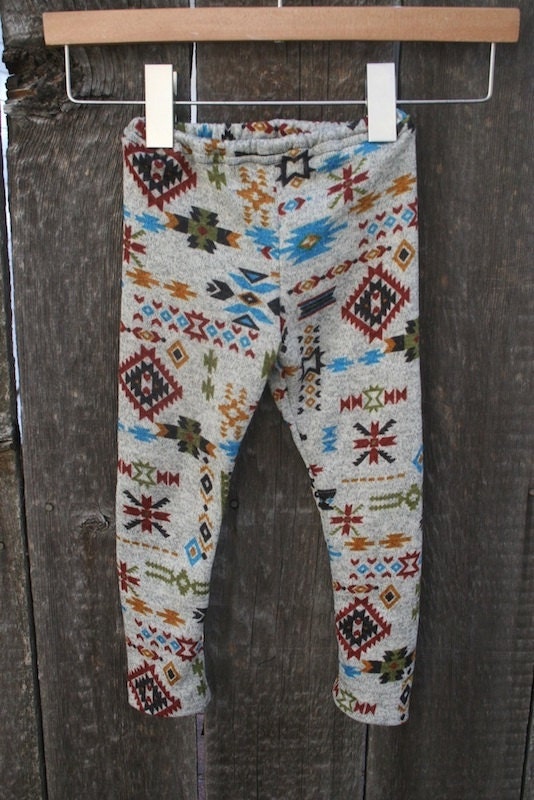 All Listings The stretch knit leggings feel comfortable and give a fun pop with the tribal print. Set: Shirt, vest and leggings Shirt: Scoop neck, long sleeves, snap-button back closure, sheer ruffle hem.