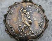 A large, lanquid Aphrodite and her royal cherubs..vintage brass filigree and sheer glory..