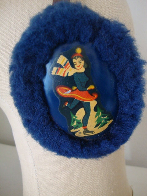 antique retro ice skater earmuffs with metal ear pieces with decal of skater