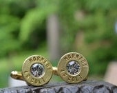 Bullet cufflinks fashioned from repurposed gold/brass Hornady .45 Long Colt shell casings with clear Swarovski crystals