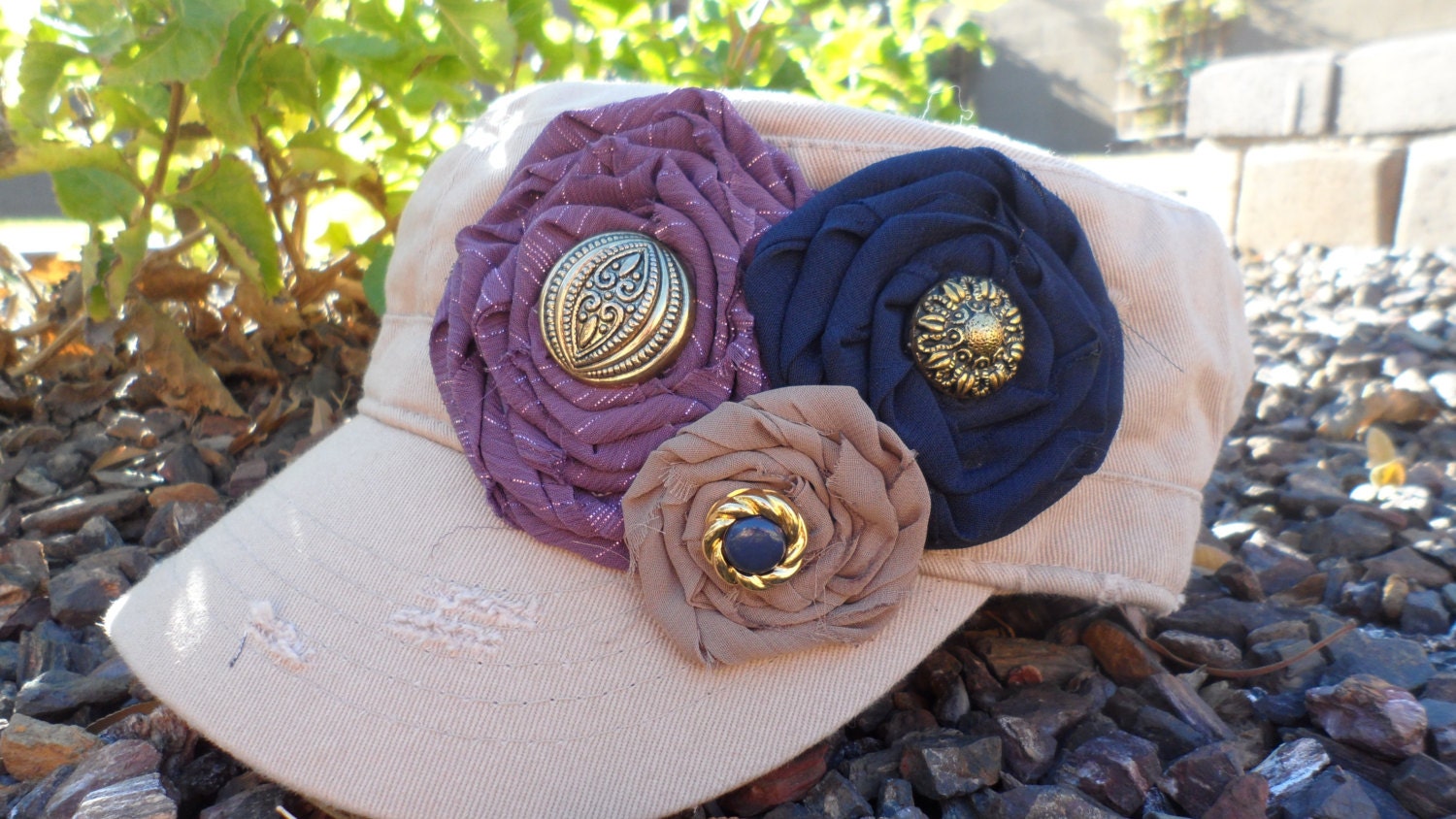 Stone Military Style Cadet Hat With a Purple, Navy Blue, and Cocoa Rolled Rosettes