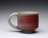 handmade teacup, stoneware mug with bright red and green celadon glazes