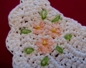 White crocheted stoma cover with hand embroidered flowers