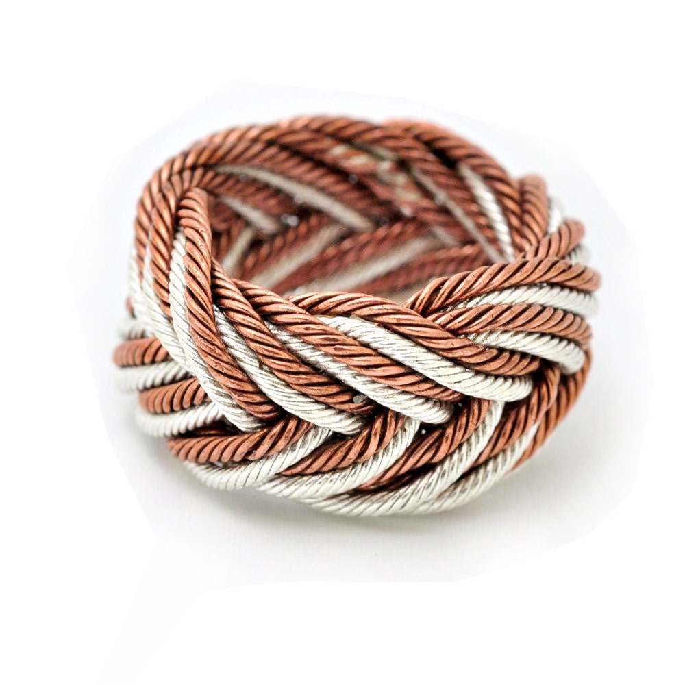 A knot ring, woven with fine silver and copper wire.