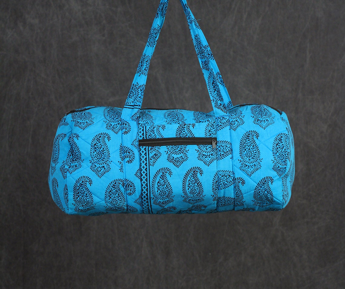 Quilted Duffle bag in Turquoise with Red Paisley Print.