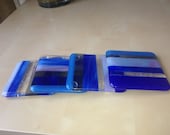 A set of blue-themed fused glass coasters with rubber stopper