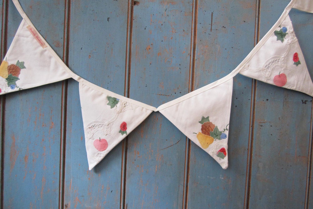 Vintage Tablecloth Bunting.  It's an off white colour and has some lovely hand appliqued details.