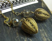 ALL FALL DOWN. Antiqued brass filigree bulbs and smoky quartz rondelle earrings.